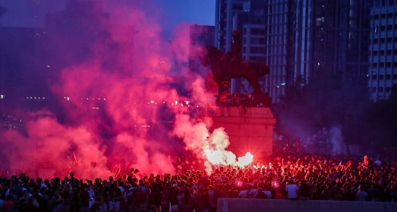Liverpool fans let off flares outside the Liver Building in Liverpool. PA