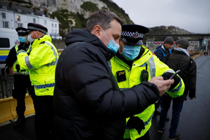 A driver talks with a police officer next the exit of the Port of Dover, as EU countries impose a travel ban from the UK following the coronavirus disease (COVID-19) outbreak, in Dover, Britain, December 23, 2020. REUTERS