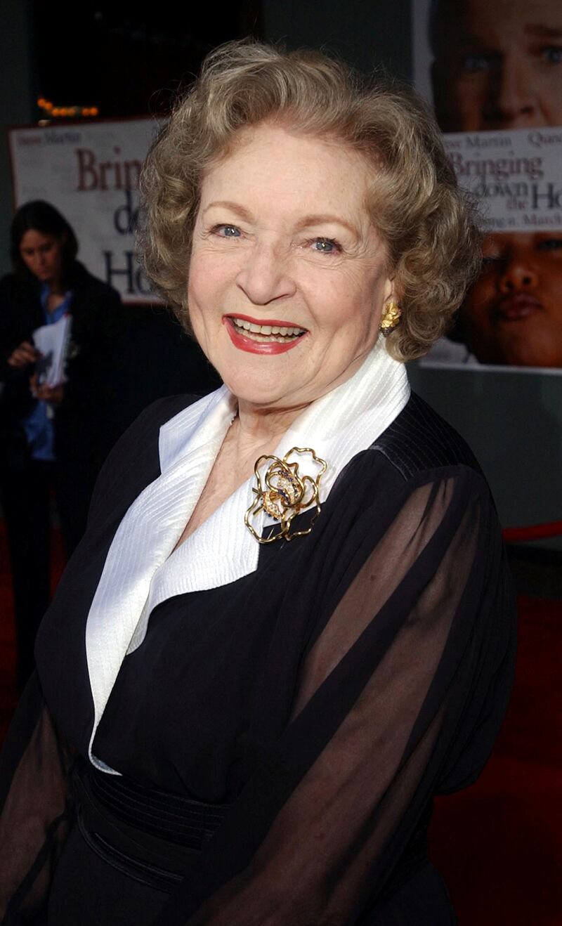 Betty White, in a black dress with a white collar and gold flower broach, attends the 'Bringing Down the House' premiere in Los Angeles on March 2, 2003. Reuters