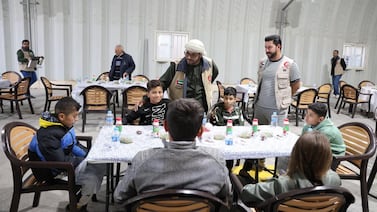 Emirates Red Crescent volunteers with Syrian refugees at the Mrajeeb Al Fhood camp. Photo: Wam