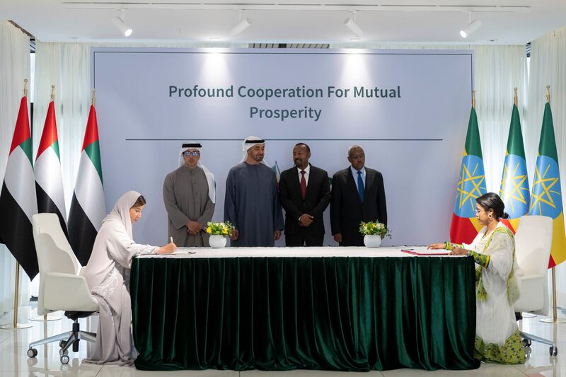 President Sheikh Mohamed and Mr Abiy witness a signing ceremony. Signing on behalf of the UAE is Raja Al Mazrouei, board member and managing director of Etihad Credit Insurance