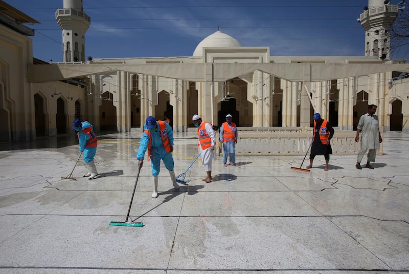 Volunteers disinfects a mosque on the first day of Ramadan, in Peshawar, Pakistan. AP Photo