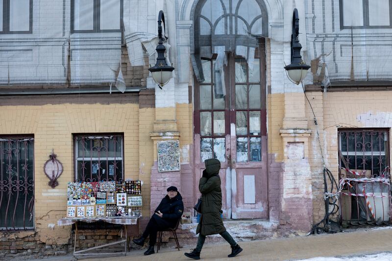 A woman walks past a vendor on a street in the Ukrainian capital. Getty Images