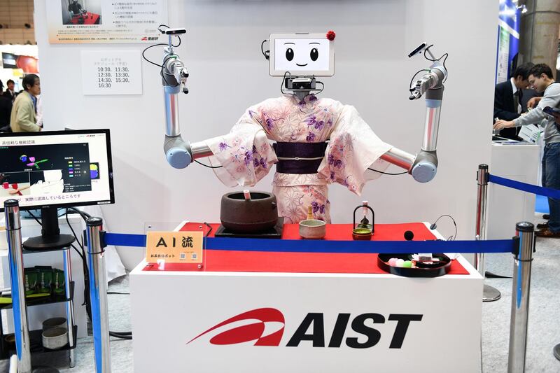 An artificial intelligence robot developed by the National Institute of Advanced Industrial Science and Technology stands displayed at CEATEC Japan in Chiba, Japan. Bloomberg