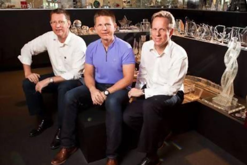 The three Hohmann bothers - left to right, Uwe, Wolfgang and Lothar - take a seat at Lothar's Precise Group premises. Antonie Robertson / The National