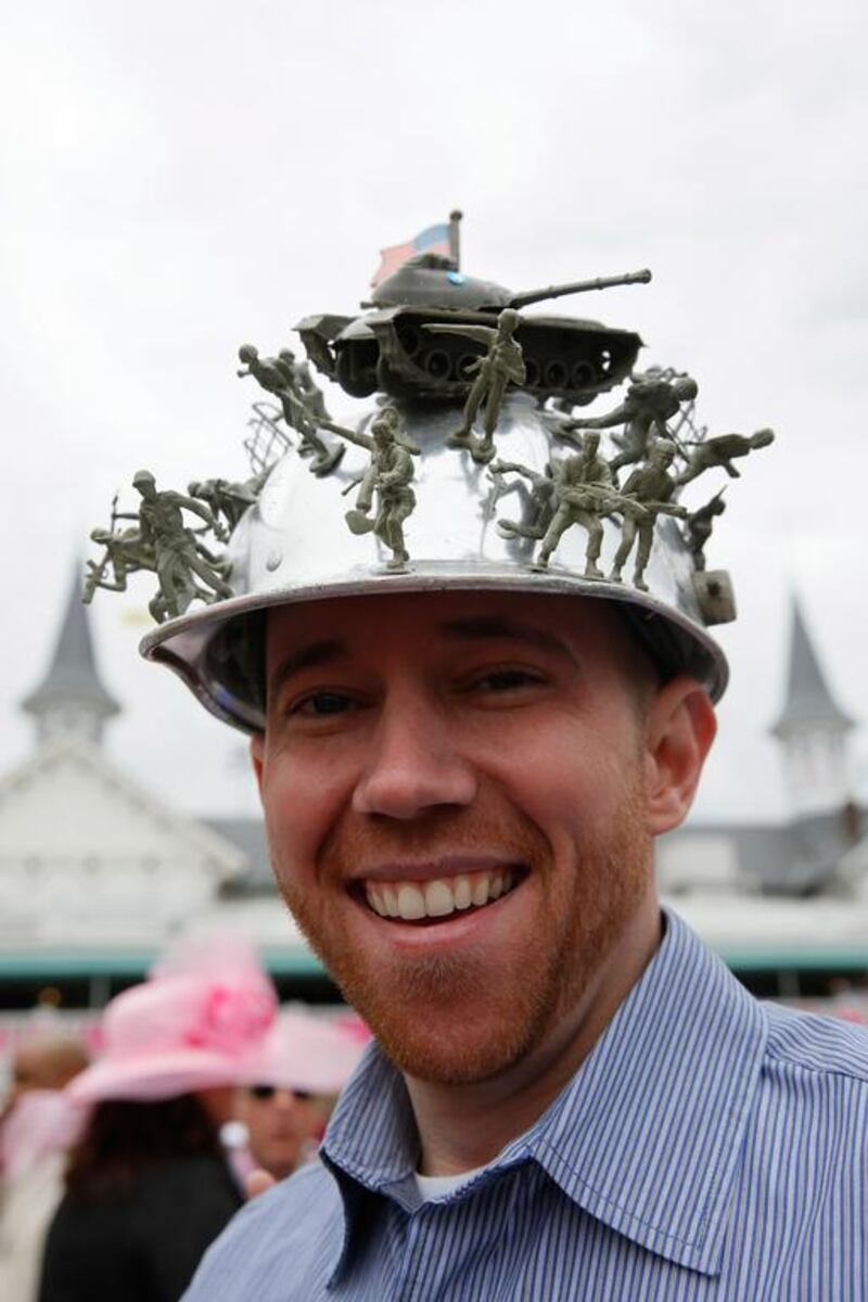 A race fan wearing a festive hat attends the 140th running of the Kentucky Oaks at Churchill Down. Kevin C. Cox / Getty Images / AFP