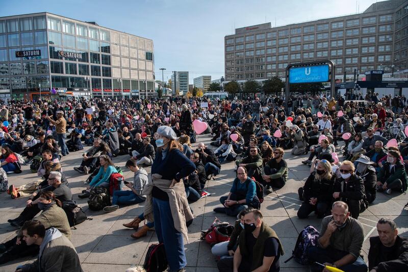 Participants in the demonstration sit on the floor at Alexanderplatz in Berlin. AP Photo