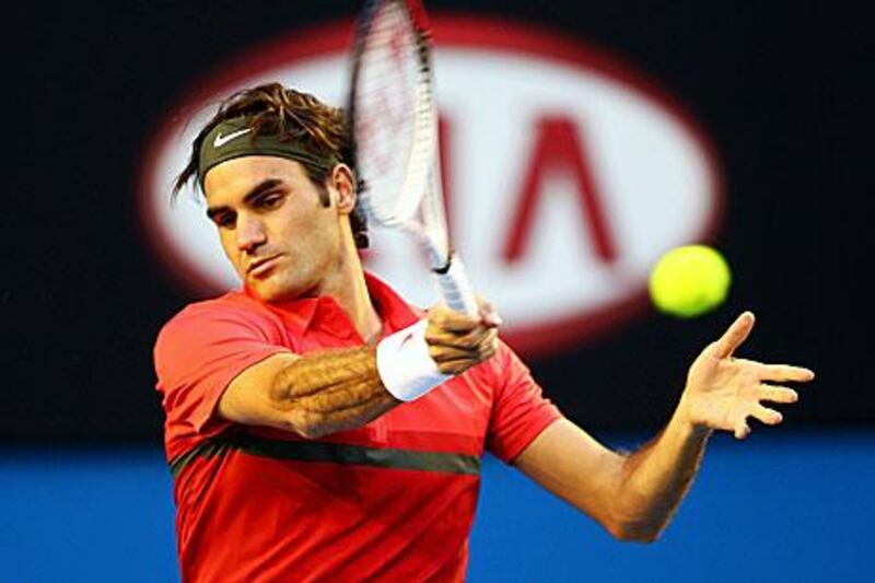 Roger Federer plays a forehand in his first-round match against Alexander Kudryavtsev.