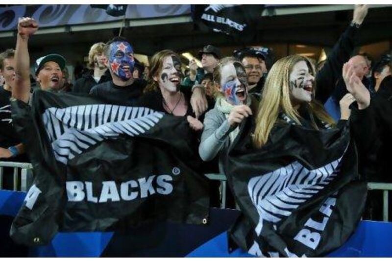 New Zealand supporters cheer their team during a Rugby World Cup match against Tonga in Auckland last month. They will be hoping for a win over Australia in the semi-final, which would take the All Blacks to within one match of winning a title that has eluded them so far.