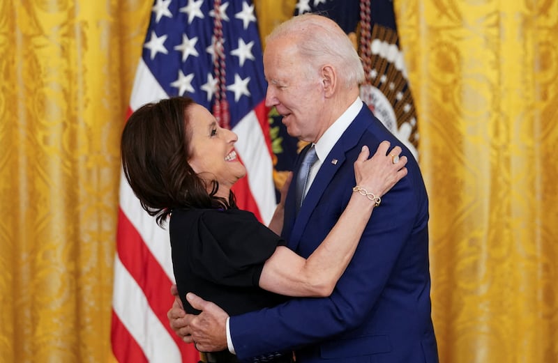 2021 National Medal of Arts recipient actress Julia Louis-Dreyfus hugs US President Joe Biden as he presents her with the medal during a ceremony in the East Room of the White House. Reuters