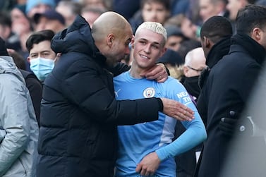 Manchester City manager Pep Guardiola embraces Phil Foden after the Premier League match at Etihad Stadium, Manchester. Picture date: Saturday January 15, 2022.