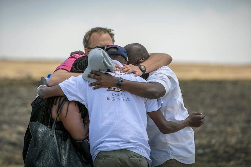 Family members and friends hug at the scene where the Ethiopian Airlines Boeing 737 Max 8 crashed shortly after takeoff on Sunday killing all 157 on board. AP