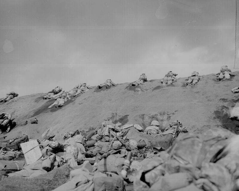 US marines of the Fifth Division inch their way up a slope towards Mount Suribachi on Iwo Jima, on February 19, 1945. Reuters