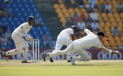 Cricket-England v Sri Lanka, Second Test - Pallekele, Sri Lanka - November 15, 2018. England's Ben Stokes (R) drops the ball hit by Sri Lanka's Dimuth Karunaratne (C). REUTERS/Dinuka Liyanawatte