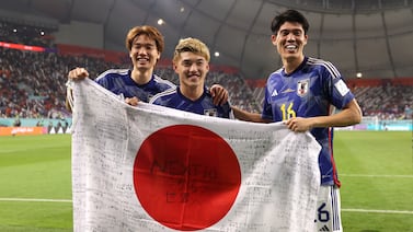 DOHA, QATAR - DECEMBER 01: Kou Itakura, Ritsu Doan and Takehiro Tomiyasu of Japan celebrate their 2-1 victory and qualification for the knockout stage after the FIFA World Cup Qatar 2022 Group E match between Japan and Spain at Khalifa International Stadium on December 01, 2022 in Doha, Qatar. (Photo by Ryan Pierse / Getty Images)