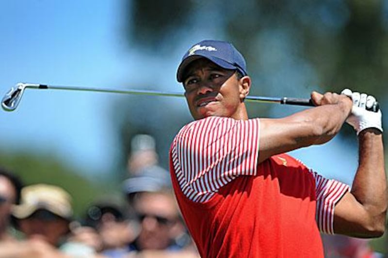Tiger Woods, pictured today in a practice round for the US in the Presidents Cup in Australia, has confirmed his participation in the Abu Dhabi Golf Championship in January.