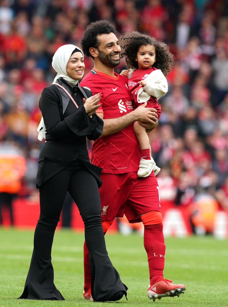 Liverpool's Mohamed Salah walks the pitch with his family. PA