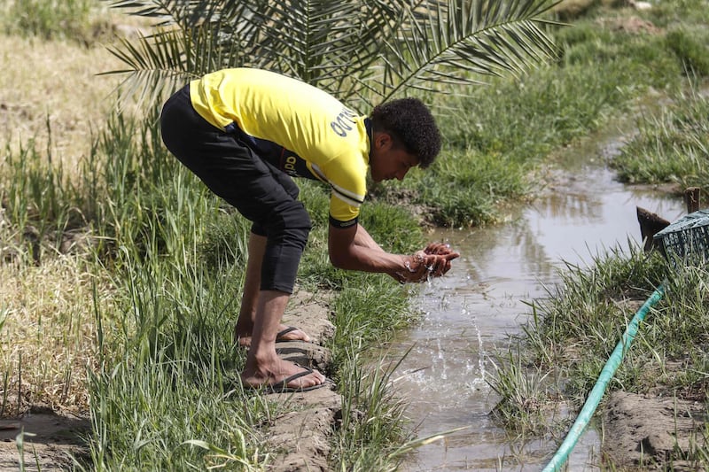 An Iraqi youth washes his hands in a stream of water in the village of Sayyed Dakhil. Haidar Mohammed Ali / AFP
