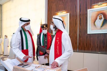 Sheikh Mohammed bin Rashid, Prime Minister and Ruler of Dubai, looks at the new UAE passport design during a Cabinet meeting on Sunday. Courtesy: Sheikh Mohammed bin Rashid Twitter