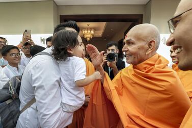 Mahant Swami Maharaj, the spiritual leader of Baps Swaminarayan Sanstha, the organisation building the temple, blesses a child during his visit to Dubai. Victor Besa/The National