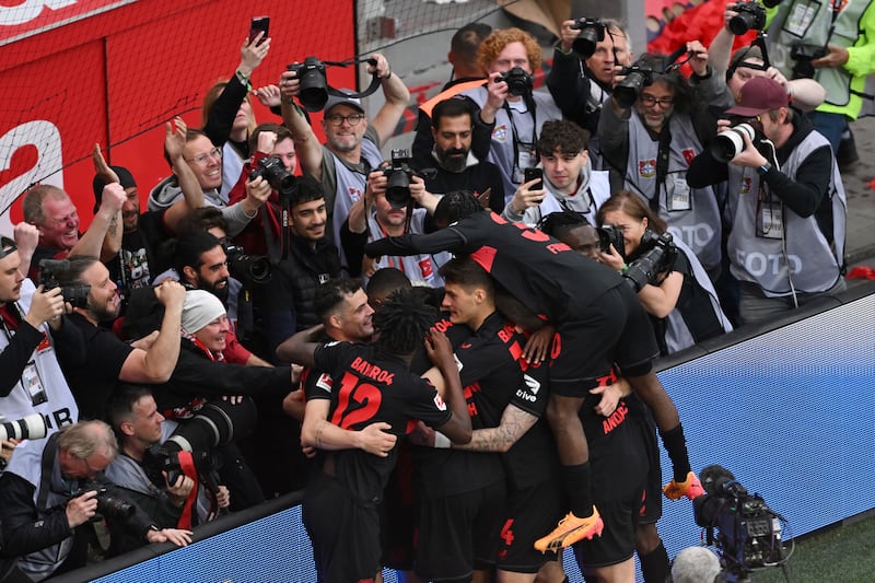 Leverkusen players celebrate after scoring their side's fifth goal of the game against Werder Bremen. AP