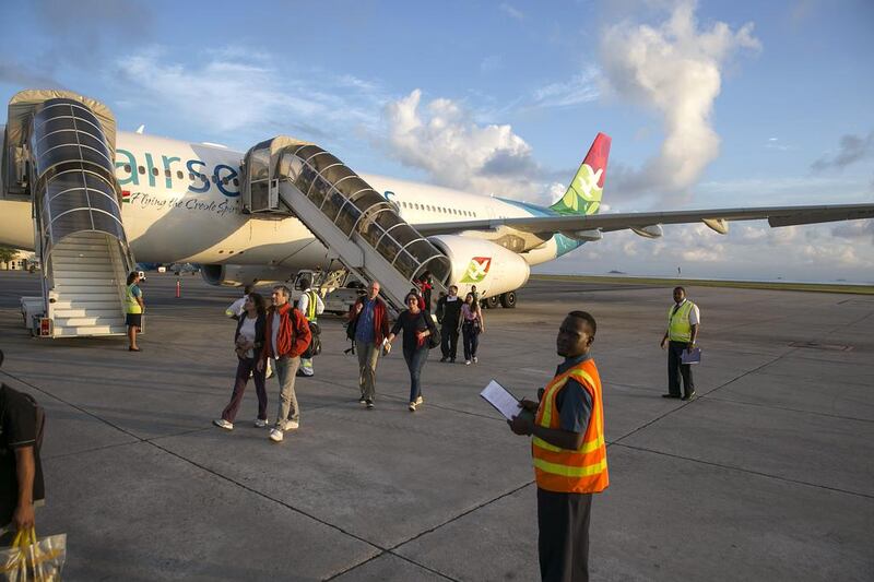 Passengers disembark an Air Seychelles plane at Victoria airport early on the morning of Saturday, March 7, 2015. The airline is to launch code-share agreements with India’s Jet Airways and Air Mauritius during the second quarter of this year. Silvia Razgova / The National