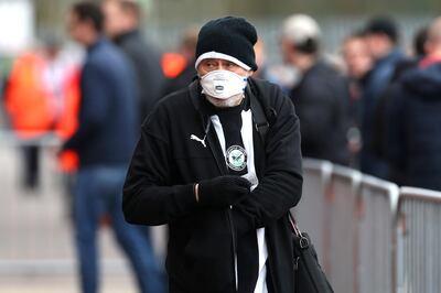 A Newcastle United fan with a face mask in preparation in the control of the coronavirus outside the ground before the Premier League match at St Mary's Stadium, Southampton. PA Photo. Picture date: Saturday March 7, 2020. See PA story SOCCER Southampton. Photo credit should read: Mark Kerton/PA Wire. RESTRICTIONS: EDITORIAL USE ONLY No use with unauthorised audio, video, data, fixture lists, club/league logos or "live" services. Online in-match use limited to 120 images, no video emulation. No use in betting, games or single club/league/player publications.