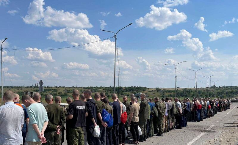 Ukrainian prisoners of war, who were released as part of a prisoner swap with Russia, walk towards the Ukrainian side at an undisclosed location. EPA.