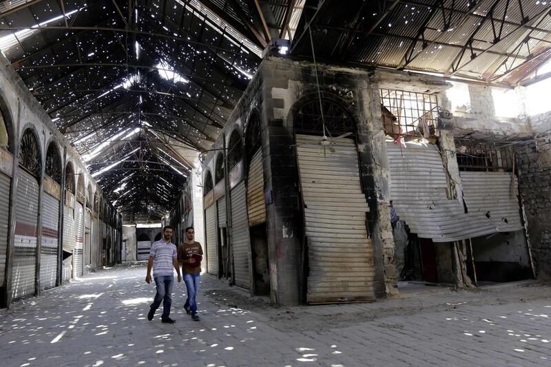 Syrian men walking in an alley at the ancient market in the heart of the mostly government-controlled Syrian city of Homs which was in ruins when its Old City was recaptured from rebels by government troops in 2014 after a two-year siege and near-daily bombardment. A UN-backed project is now trying to restore the 13th century ancient souk. Louai Beshara/AFP