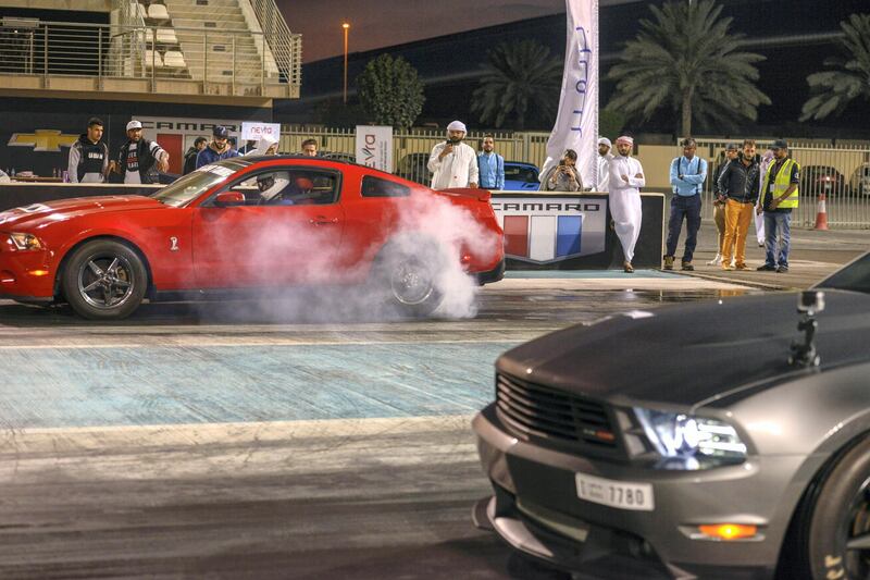Abu Dhabi, United Arab Emirates - Mustangs burn out before the race, at the Drag Race Car Show event sponsored by Premium Motors & organized by Emirates Mustang Club at Yas Marina Circuit on January 29, 2018. (Khushnum Bhandari/ The National)