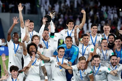 FILE - In this Saturday, Dec. 22, 2018 file photo, Real Madrid players celebrate with the trophy after winning the Club World Cup at Zayed Sport City in Abu Dhabi, United Arab Emirates. FIFA Council members will be asked on Friday March 15, 2019, to approve a pilot of an expanded 24-team Club World Cup in June-July 2021, The Associated Press has learned. A revamp of the current annual December seven-team competition is being pursued by FIFA President Gianni Infantino despite ongoing opposition from Europe, with the long-term vision of the bigger Club World Cup being staged every four years. (AP Photo/Hassan Ammar, File)