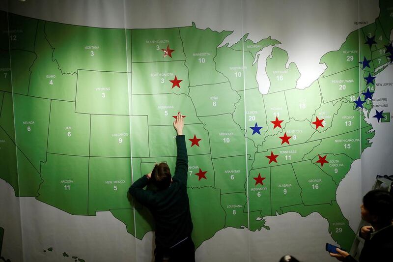 A man marks a star on the Electoral College map during a election event hosted by the US Embassy at a hotel in South Korea. Kim Hong-Ji  / Reuters