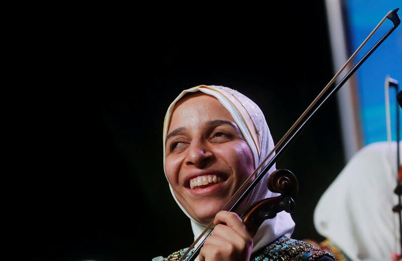 Heba Ahmed, 25, a member of Al Nour Wal Amal (Light and Hope) chamber orchestra for blind women smiles during the first concert at the Manasterly Palace in Cairo, Egypt. Reuters