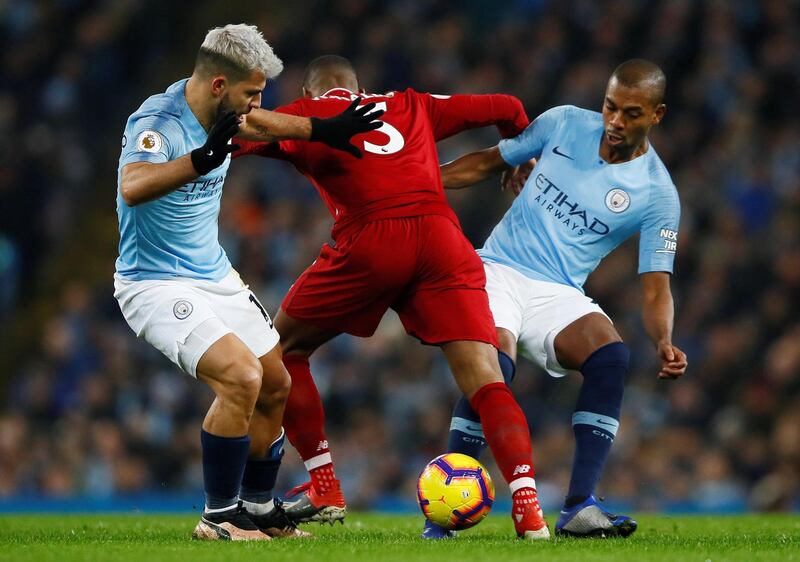 Soccer Football - Premier League - Manchester City v Liverpool - Etihad Stadium, Manchester, Britain - January 3, 2019  Manchester City's Sergio Aguero and Fernandinho in action with Liverpool's Georginio Wijnaldum   Action Images via Reuters/Jason Cairnduff  EDITORIAL USE ONLY. No use with unauthorized audio, video, data, fixture lists, club/league logos or "live" services. Online in-match use limited to 75 images, no video emulation. No use in betting, games or single club/league/player publications.  Please contact your account representative for further details.