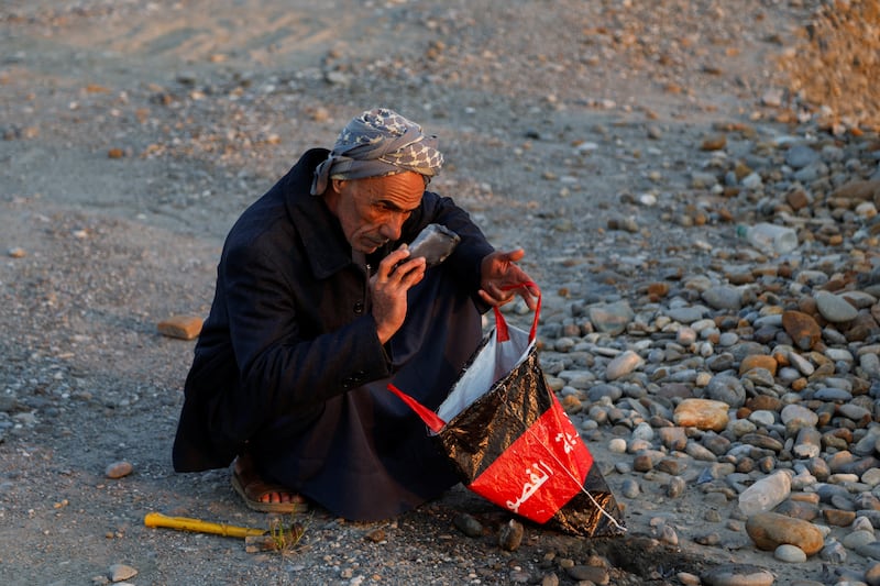 Mr Suaan searches for gemstones near the Tigris river, which bisects Mosul