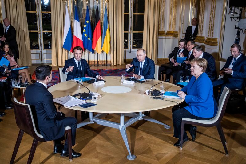 Mr Zelenskyy, Mr Macron, Mr Putin and then-German chancellor Angela Merkel attend a summit on Ukraine at Elysee Palace in Paris in December 2019. Getty Images