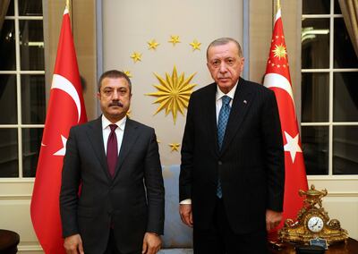 Central Bank Governor Sahap Kavcioglu, left, stands with Turkish President Recep Tayyip Erdogan in Ankara, Turkey. Reuters