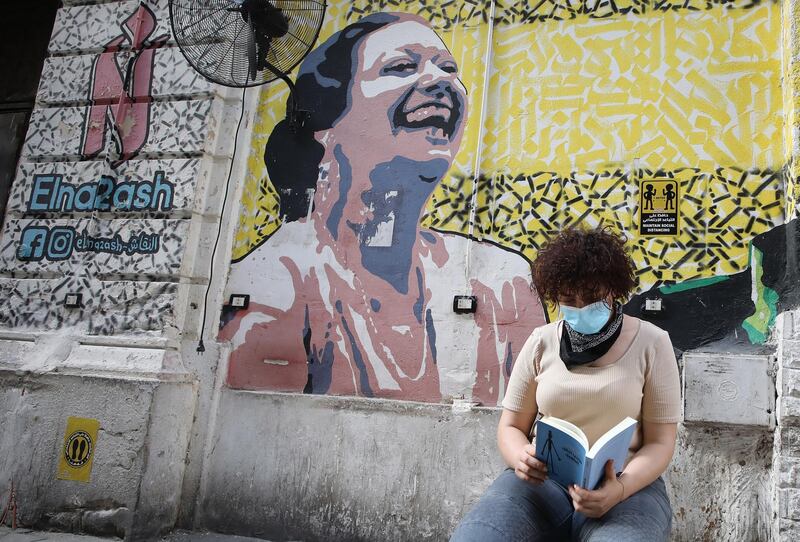 A girl reads a book in a cafe in Cairo. EPA