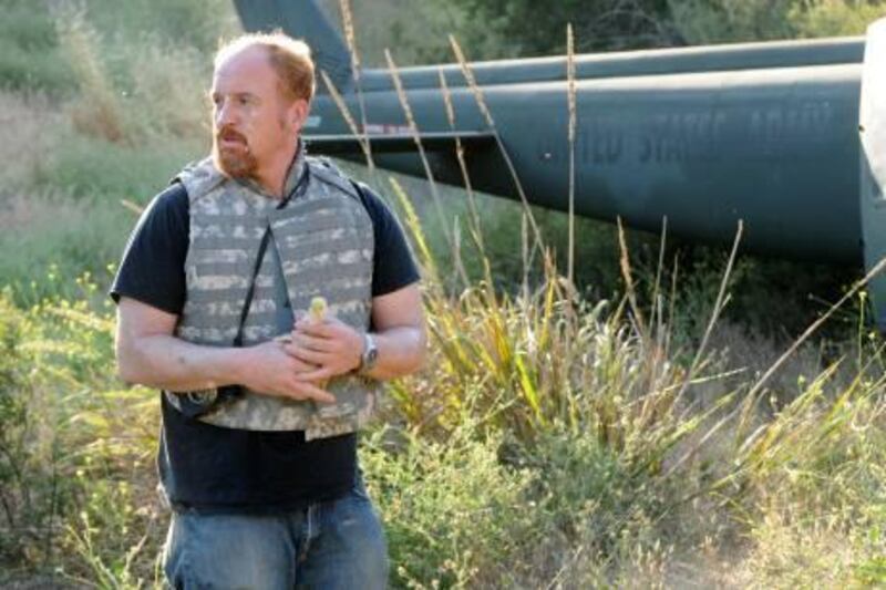 In this image released by FX, Louis C. K. is shown in a scene from "Louie," which aired Thursday, Aug. 25, 2011. In the episode, Louis' daughters sneak a pet duckling into his luggage before he travels to Iraq and Afghanistan on USO tour. Much of the episode took inspiration from C.K.'s 2008 Sergeant Major of the Army Tour, an experience that resonated for the 43-year-old comedian.(AP Photo/FX)
