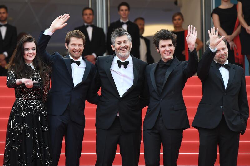 From left to right French actress Adele Wismes, French actor Pierre Deladonchamps, French director Christophe Honore, French actor Vincent Lacoste and French actor Denis Podalydes wave as they arrive for the film Sorry Angel.  Anne-Christine Poujoulant / AFP