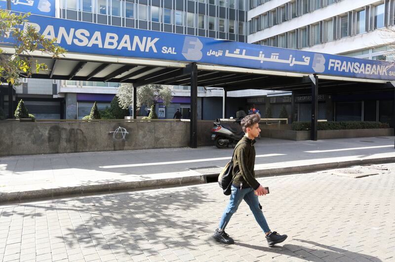 A man walks near a branch of Fransabank in Beirut, Lebanon, on March 8. Reuters