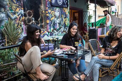 Eden Kavishy, 22, with Eman Atshi ,18, (center) at a table with friends at a chic cafe on Mossadeq Street in Haifa, a northern city thatÕs a cultural center of Arab and Palestinian life in Israel.
All in the group were Druze, an Arab religious minority group centered in Israel, Lebanon and Syria.
Atshi voted for Blue and White in April, but this time around sheÕs not voting at all.
ÒI voted last time and it didn't help,Ó she said of her decision to stay home and boycott.
(Photo by Heidi Levine for The National).
