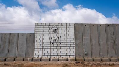 epa06925393 View of the Israeli separation fence, or wall, in Kibbutz Kerem Shalom, on the southernmost part of Israel that shares border with the Gaza Strip and Egypt, 03 August 2018. Much of the wall is covered in art works including this depiction of The Wall album cover by Pink Floyd, released in 1979 and one of the bestselling albums of all time.  EPA/JIM HOLLANDER