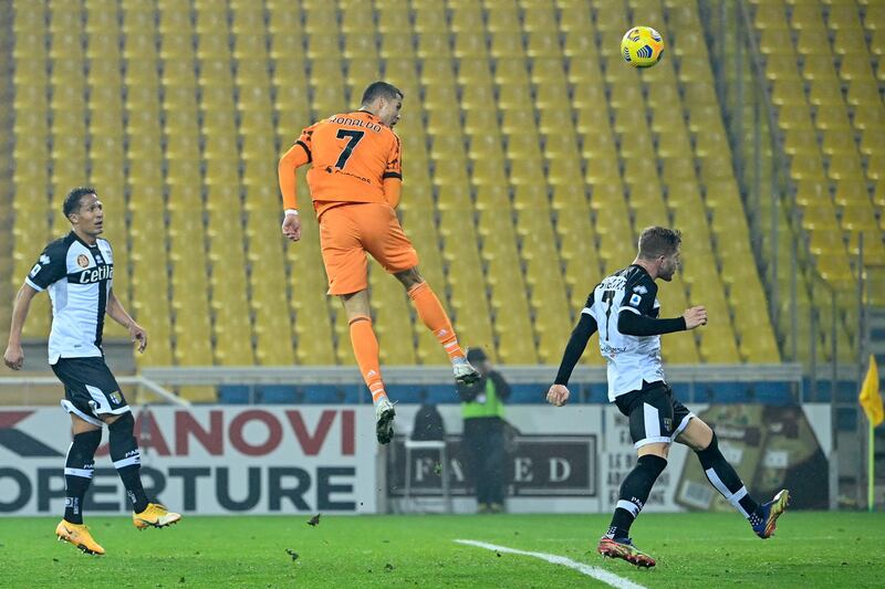 Juventus' Portuguese forward Cristiano Ronaldo jumps to score a header during the Italian Serie A football match Parma vs Juventus on December 19, 2020 at the Ennio-Tardini stadium in Parma. (Photo by Alberto PIZZOLI / AFP)