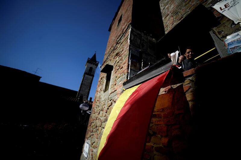 The village's red and yellow flag and the Santa Croce church. AFP