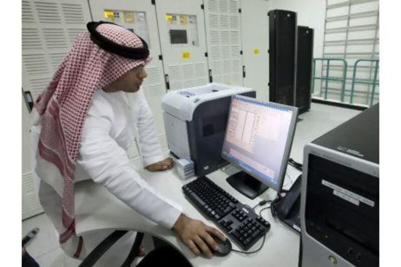 An employee monitors data at Etisalat's internet submarine cable landing facilities in Fujairah.