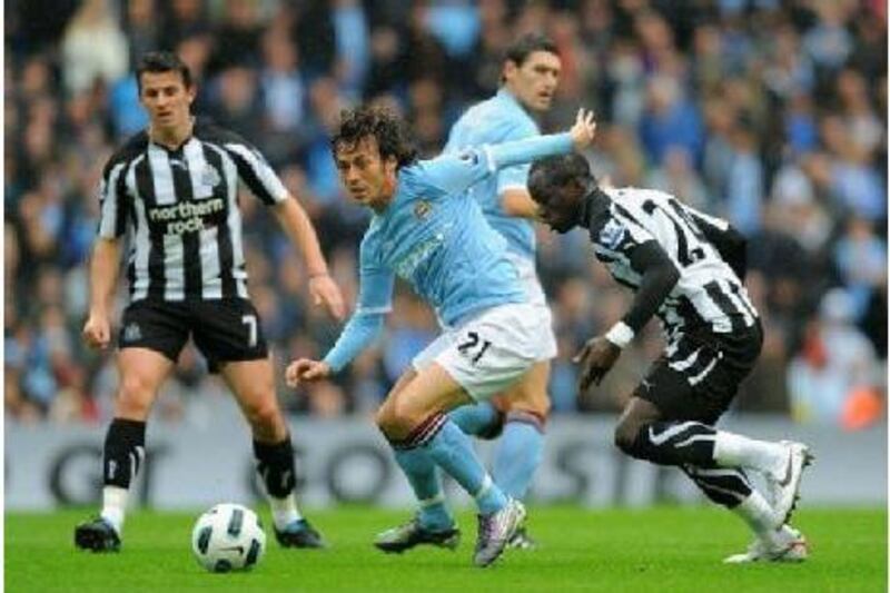 MANCHESTER, ENGLAND - OCTOBER 03: Joey Barton (L) and Cheik Ismael Tiote of Newcastle in action with David Silva (C) of Manchester City during the Barclays Premier League match between Manchester City and Newcastle United at the City of Manchester Stadium on October 3, 2010 in Manchester, England. (Photo by Michael Regan/Getty Images) *** Local Caption *** GYI0061909022.jpg