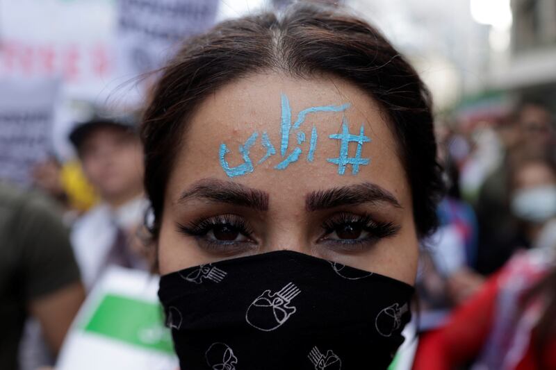An Iranian woman living in Turkey with 'Freedom' written on her forehead takes part in a protest near the Iranian consulate in Istanbul. Reuters