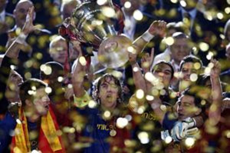 Barcelona captain Carles Puyol lifts the Champions League trophy on Wednesday night at the Stadio Olimpico in Rome.