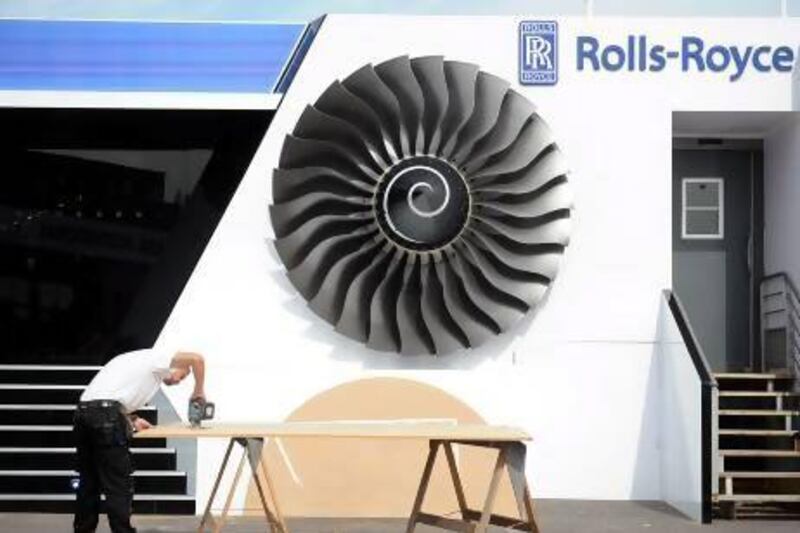 An employee works on the Rolls Royce stand at the Paris Air Show on Friday. Antoine Antoine for The National